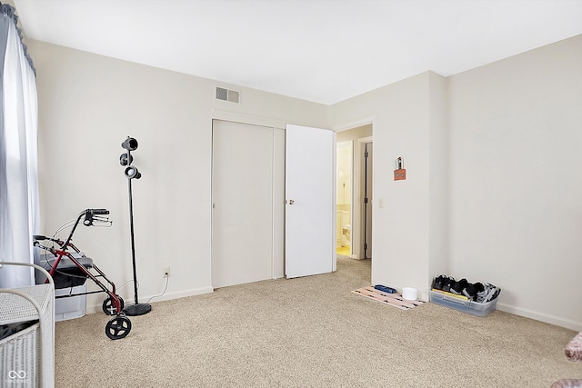 interior space featuring carpet, visible vents, and baseboards