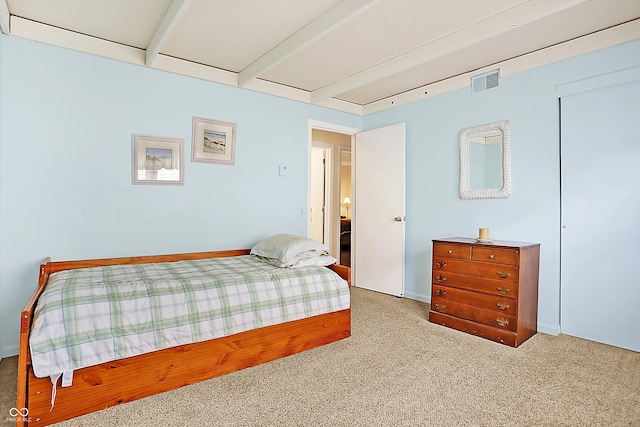 carpeted bedroom featuring visible vents and beamed ceiling