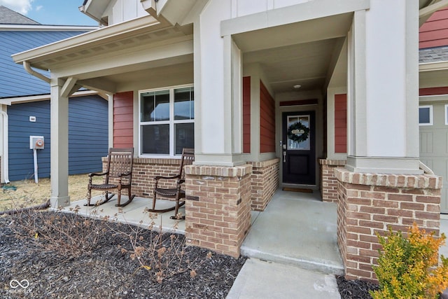 property entrance with covered porch and brick siding