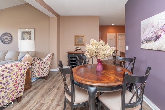 dining area featuring light wood-type flooring and baseboards