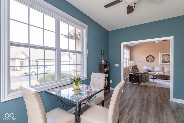 dining area featuring ceiling fan, dark wood-type flooring, a textured ceiling, and baseboards