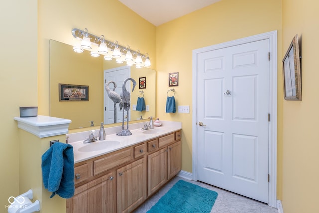 bathroom featuring tile patterned flooring, a sink, and double vanity