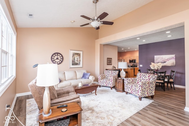 living area featuring recessed lighting, baseboards, visible vents, and light wood finished floors