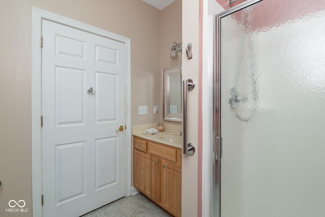 full bath featuring a stall shower, vanity, and tile patterned floors