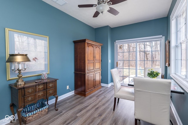 office space with a ceiling fan, baseboards, a wealth of natural light, and wood finished floors