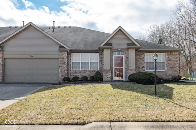 ranch-style home featuring a garage, concrete driveway, brick siding, and a front lawn