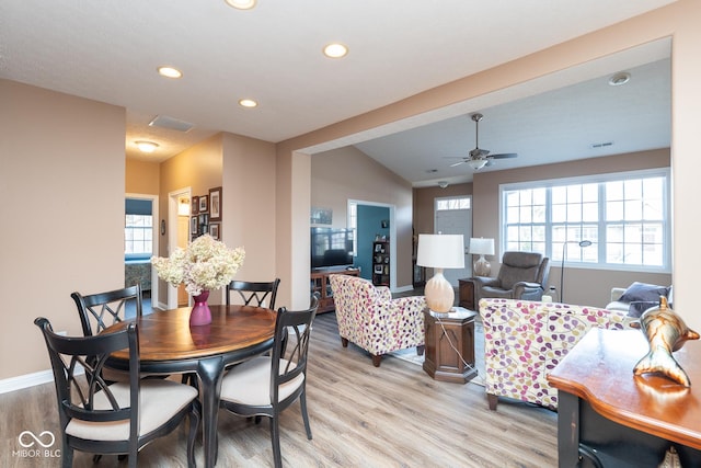 dining area with visible vents, baseboards, lofted ceiling, light wood-type flooring, and recessed lighting