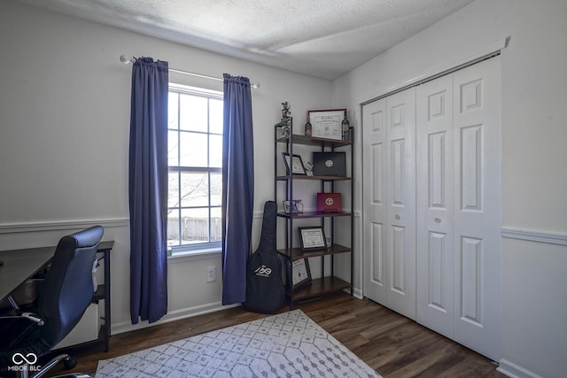 office space with baseboards, a textured ceiling, and wood finished floors