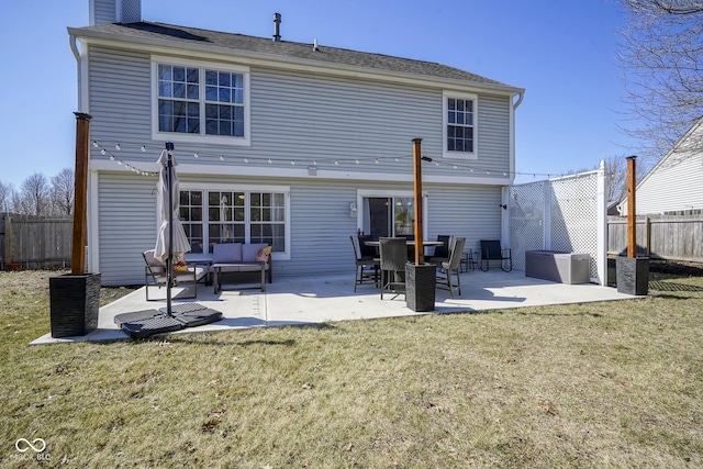 back of property with a patio, fence, a lawn, and an outdoor hangout area