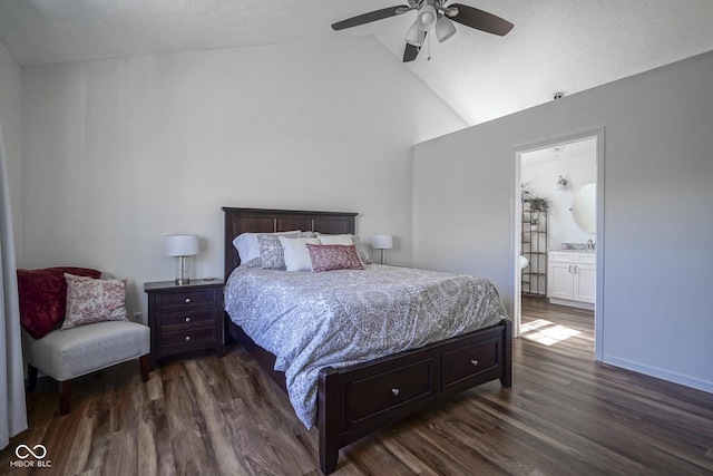 bedroom featuring lofted ceiling, a ceiling fan, ensuite bath, dark wood-style floors, and baseboards