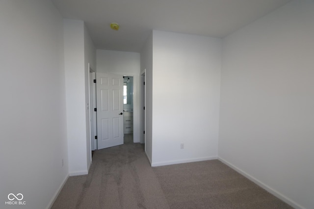 interior space with baseboards and carpet flooring