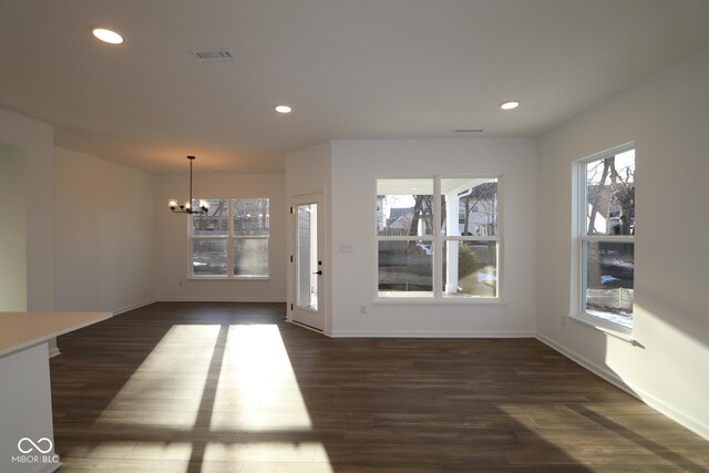 interior space with dark wood-type flooring, visible vents, and recessed lighting