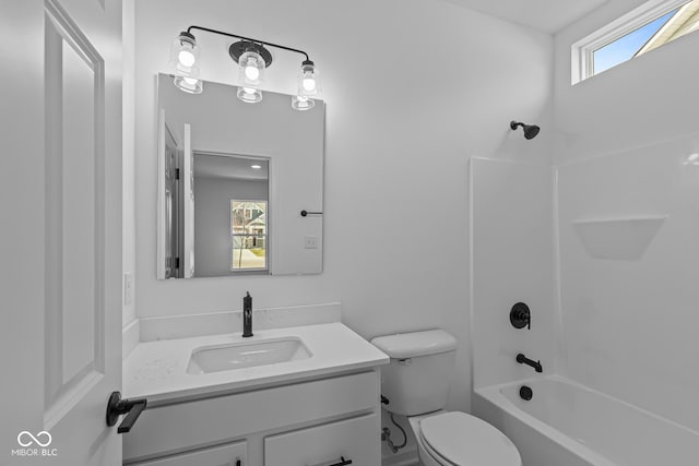 bathroom featuring toilet, vanity, and washtub / shower combination
