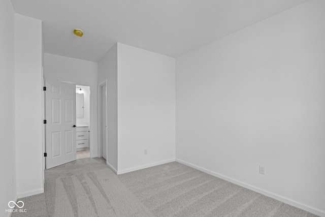 unfurnished bedroom featuring baseboards and light colored carpet
