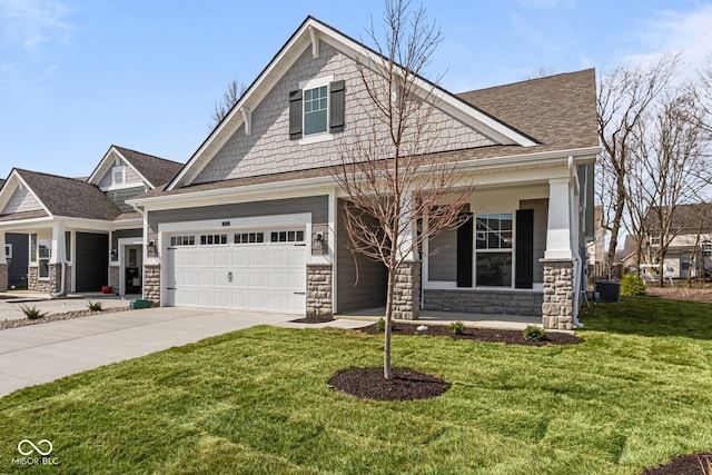 craftsman-style house featuring stone siding, driveway, a front lawn, and an attached garage