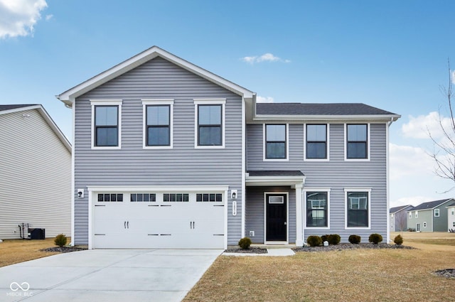 traditional-style home featuring an attached garage, a front lawn, and concrete driveway