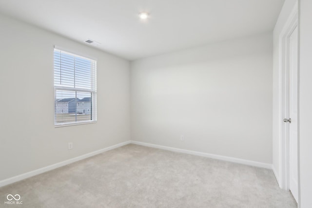 unfurnished bedroom featuring light colored carpet, visible vents, and baseboards