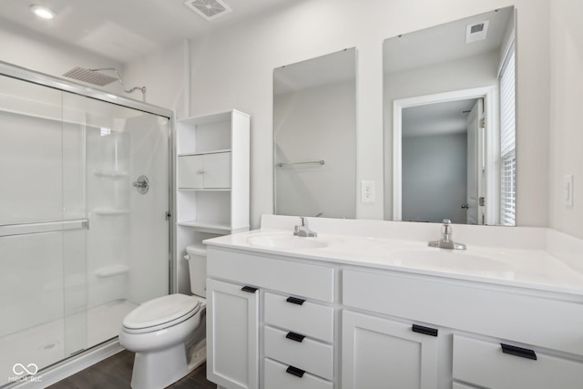 full bath featuring toilet, a stall shower, visible vents, and a sink