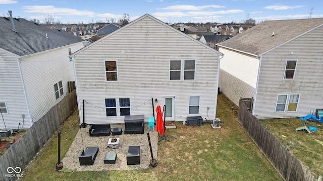 rear view of property with a fenced backyard, central AC, and a lawn