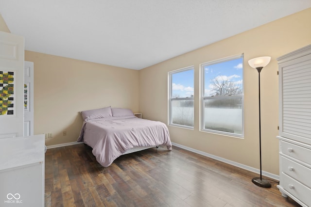 bedroom featuring baseboards and wood finished floors