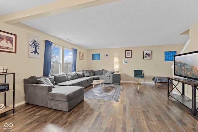 living area featuring a textured ceiling, dark wood-style flooring, visible vents, and baseboards