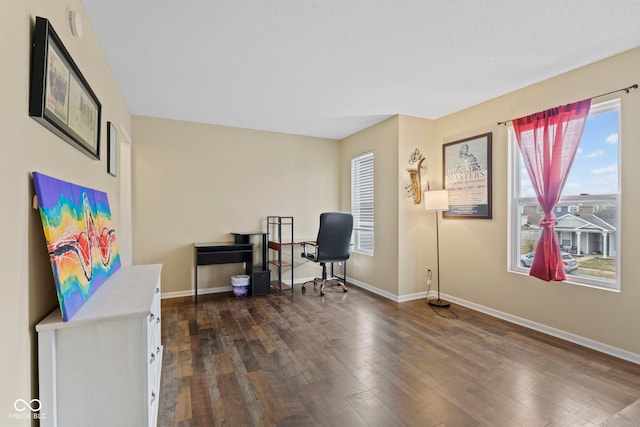 office space with dark wood-style flooring and baseboards