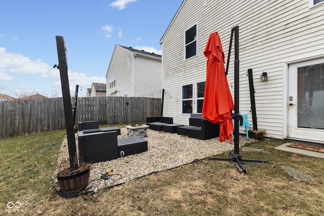 view of yard with an outdoor living space with a fire pit and a fenced backyard