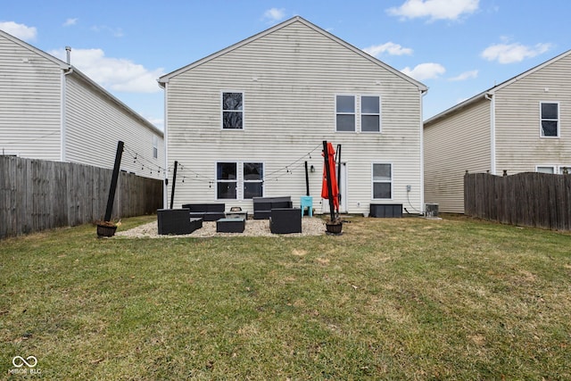 back of property featuring a fenced backyard, a yard, and an outdoor living space