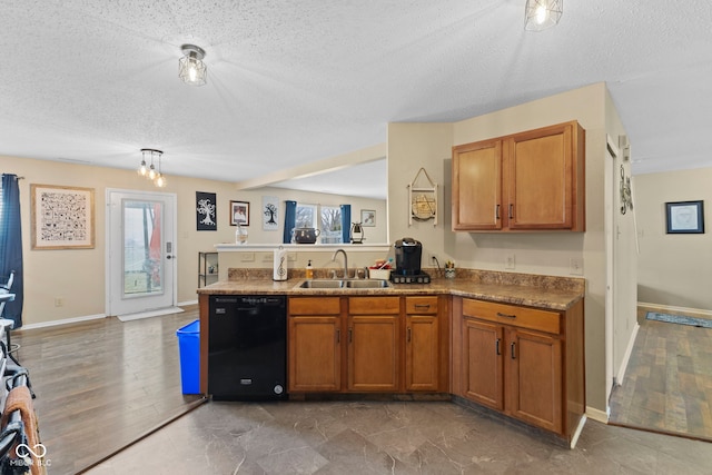 kitchen featuring brown cabinets, dishwasher, a peninsula, and a sink