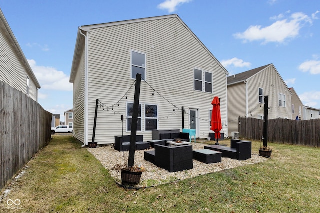 back of house with a lawn, an outdoor living space with a fire pit, and fence