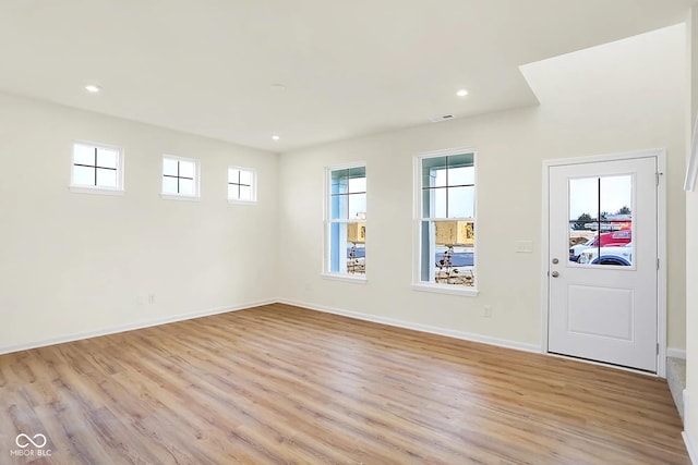 interior space featuring light wood finished floors, visible vents, baseboards, and recessed lighting