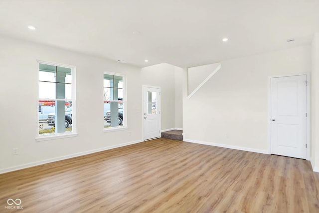 interior space with recessed lighting, light wood-style flooring, and baseboards