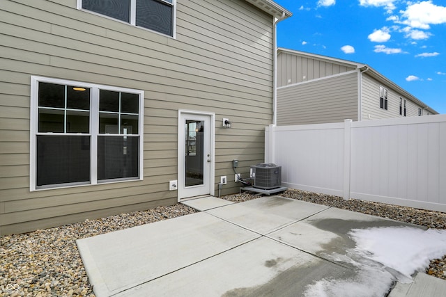 back of property with central AC, a patio area, and fence