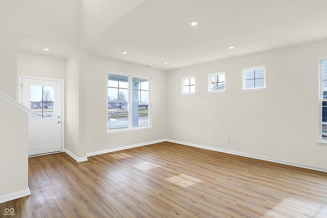 entryway featuring light wood-type flooring, baseboards, and recessed lighting