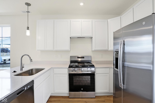 kitchen with visible vents, appliances with stainless steel finishes, light countertops, and a sink