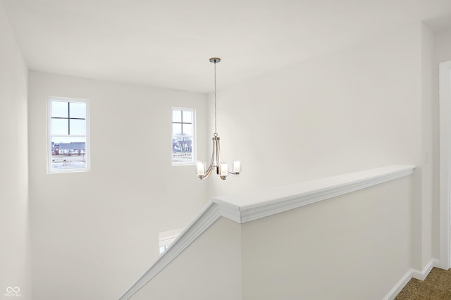 interior details with an inviting chandelier and baseboards