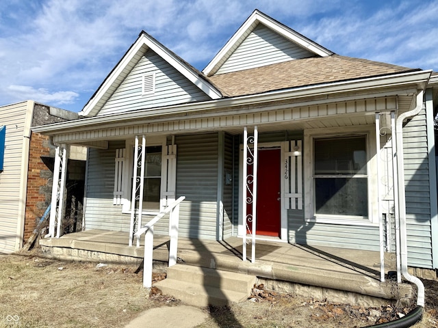 view of front of house with a porch and roof with shingles