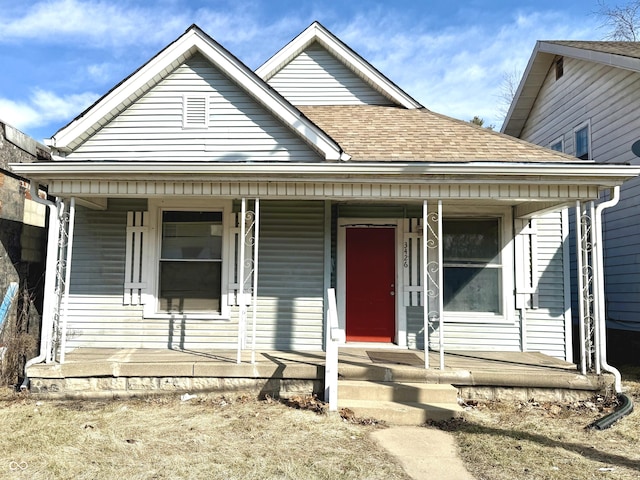 view of front of home featuring a shingled roof and covered porch