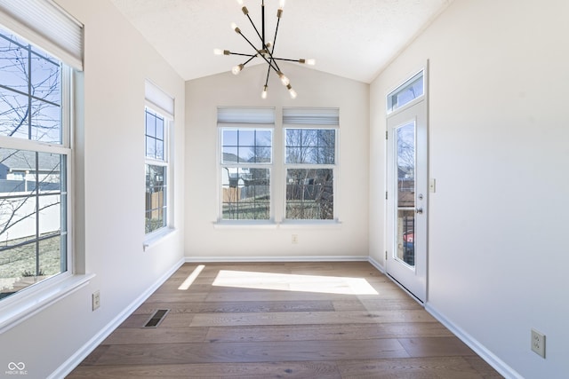 unfurnished sunroom with visible vents, vaulted ceiling, and an inviting chandelier