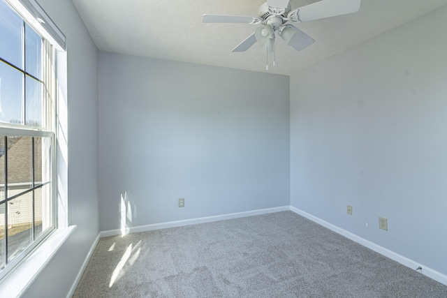 spare room featuring a ceiling fan, a textured ceiling, baseboards, and carpet flooring