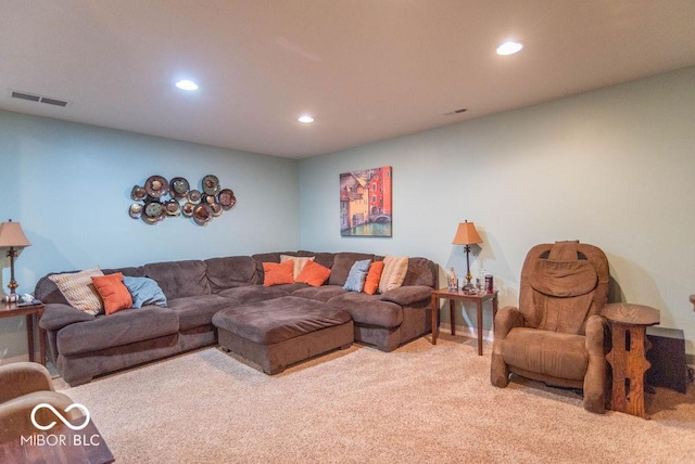 carpeted living area with recessed lighting and visible vents