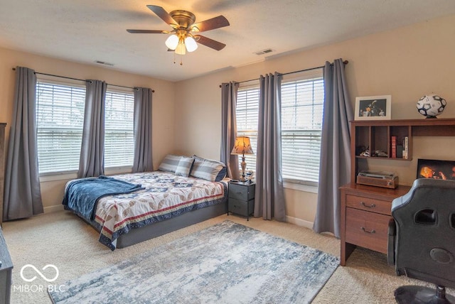 bedroom with light colored carpet, visible vents, and baseboards