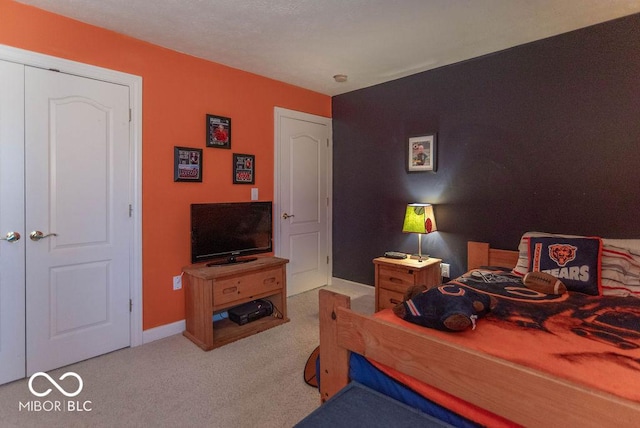 carpeted bedroom featuring baseboards