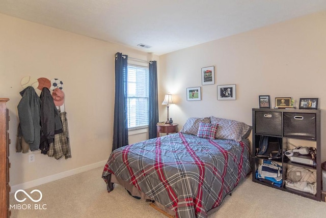 bedroom featuring carpet floors, visible vents, and baseboards