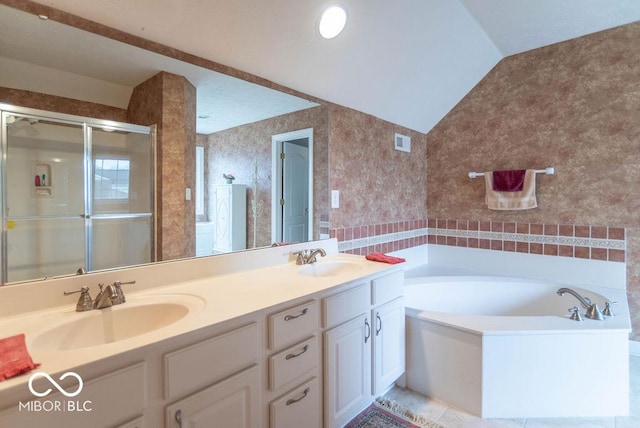 bathroom with lofted ceiling, wallpapered walls, visible vents, and a sink