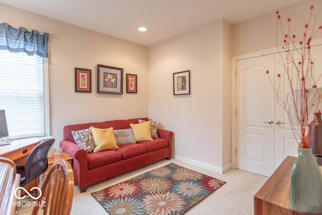 carpeted living room featuring baseboards and recessed lighting