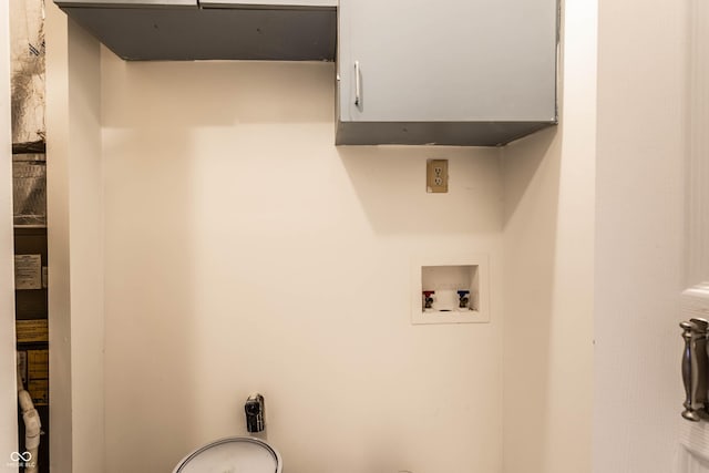 laundry room featuring hookup for a washing machine and cabinet space