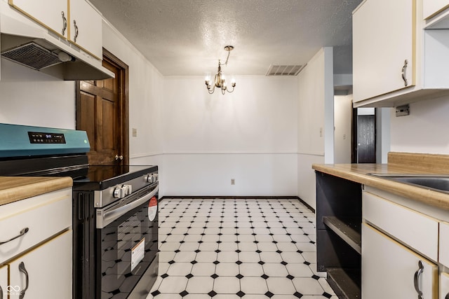 kitchen featuring electric stove, light floors, visible vents, a textured ceiling, and under cabinet range hood