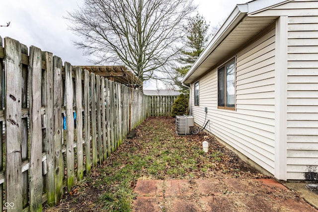 view of yard with a fenced backyard and cooling unit