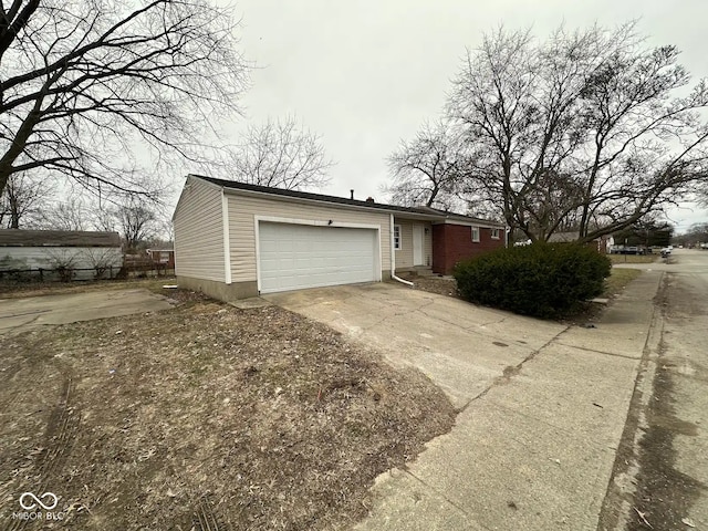 view of front of property featuring a garage and concrete driveway